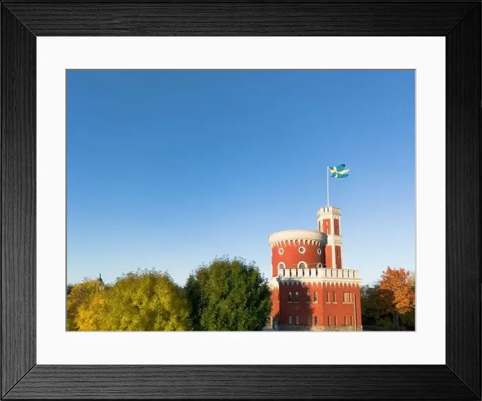 Framed Print : Kastellholmen red castle on island in Stockholm in a sunny autumn morning with turning yellow and orange trees in Sweden Framed Print : Kastellholmen red castle on island in Stockholm in a sunny autumn morning with turning yellow and orange trees in Sweden
