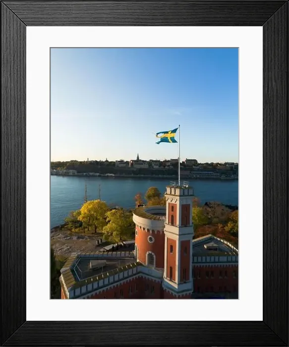 Framed Print : Kastellholmen red castle on island in Stockholm in a sunny autumn morning with turning yellow and orange trees in Sweden Framed Print : Kastellholmen red castle on island in Stockholm in a sunny autumn morning with turning yellow and orange trees in Sweden