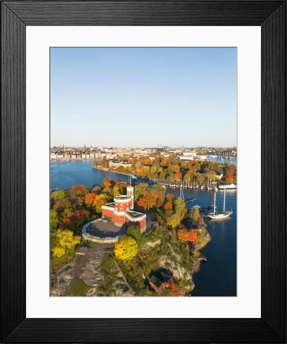 Framed Print : Kastellholmen red castle on island with Stockholm skyline in the background on a sunny autumn morning with turning Framed Print : Kastellholmen red castle on island with Stockholm skyline in the background on a sunny autumn morning with turning