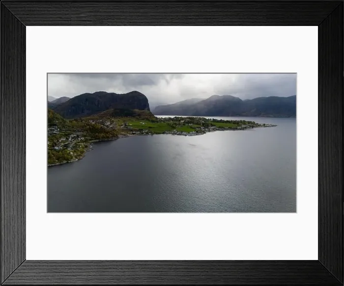 Framed Print : Aerial view of a serene fjord landscape with a small village nestled along the shore Framed Print : Aerial view of a serene fjord landscape with a small village nestled along the shore