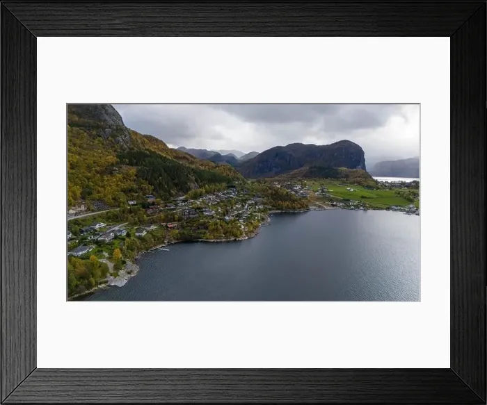 Framed Print : Aerial view of a serene fjord landscape with a small village nestled along the shore Framed Print : Aerial view of a serene fjord landscape with a small village nestled along the shore