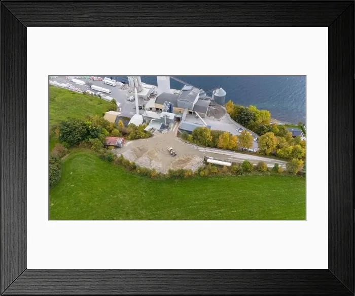 Framed Print : Aerial view of a small factory with solar panels on roof near a fjord in Norway Framed Print : Aerial view of a small factory with solar panels on roof near a fjord in Norway