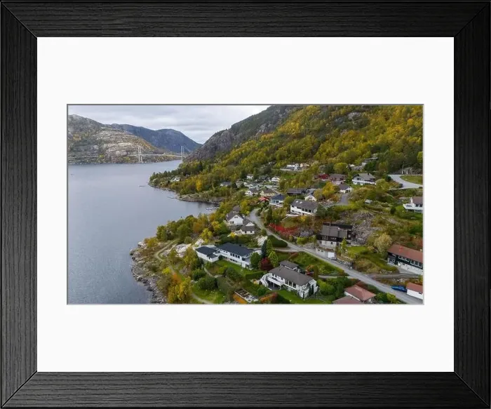 Framed Print : Aerial view of a serene fjord landscape with a small village nestled along the shore Framed Print : Aerial view of a serene fjord landscape with a small village nestled along the shore