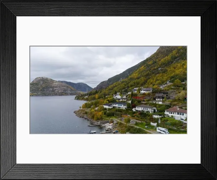 Framed Print : Aerial view of a serene fjord landscape with a small village nestled along the shore Framed Print : Aerial view of a serene fjord landscape with a small village nestled along the shore