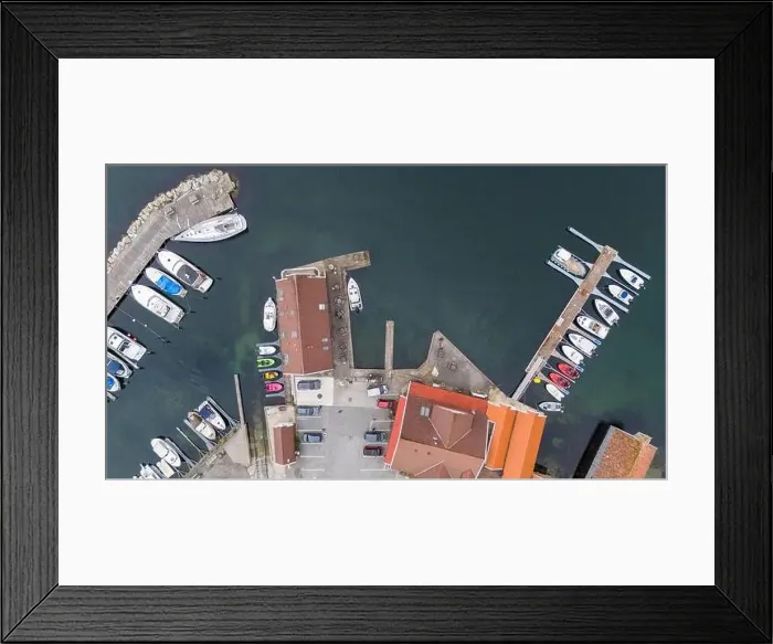 Framed Print : Aerial view of a small coastal village featuring a harbor Framed Print : Aerial view of a small coastal village featuring a harbor