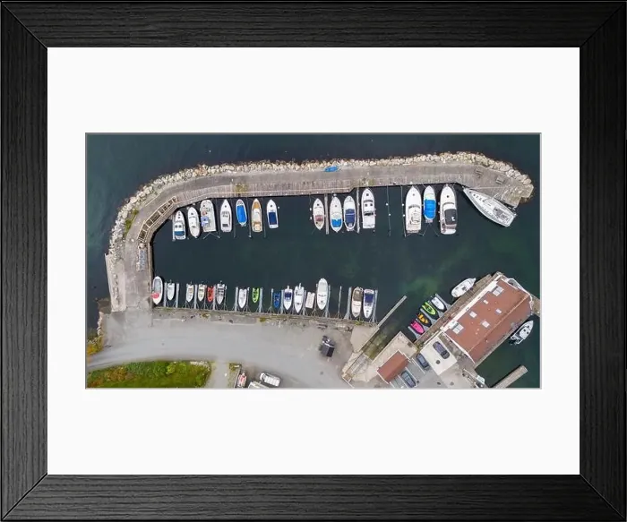 Framed Print : Aerial view of a small coastal village featuring a harbor Framed Print : Aerial view of a small coastal village featuring a harbor