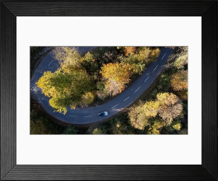 Framed Print : Car driving on a mountain road surrounded by fall season forest. Aerial photography Framed Print : Car driving on a mountain road surrounded by fall season forest. Aerial photography