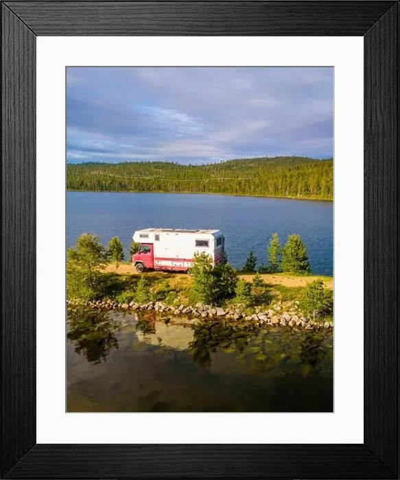 Framed Print : A red and white camper van is parked on the shore of a tranquil lake, surrounded by lush greenery and a clear blue sky Framed Print : A red and white camper van is parked on the shore of a tranquil lake, surrounded by lush greenery and a clear blue sky