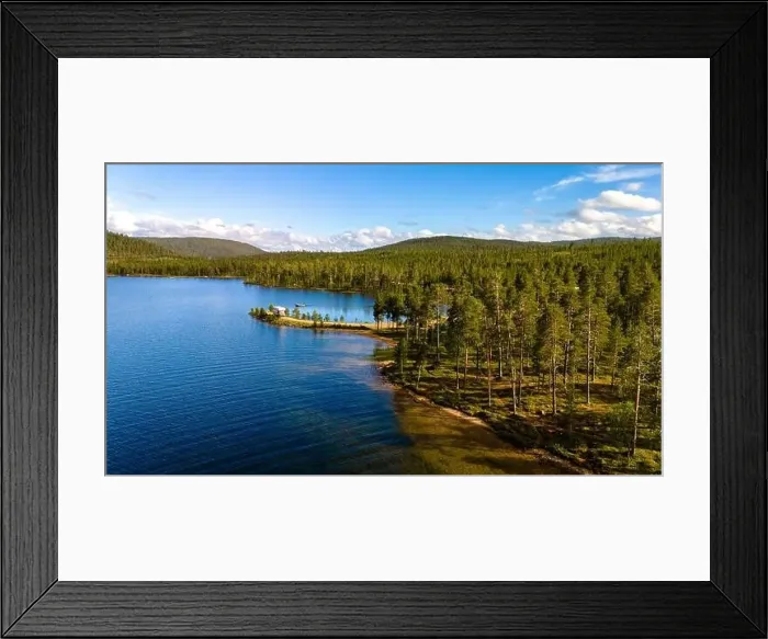 Framed Print : A tranquil, forested lake in Finnish Lapland with clear blue water and a lush green shoreline Framed Print : A tranquil, forested lake in Finnish Lapland with clear blue water and a lush green shoreline