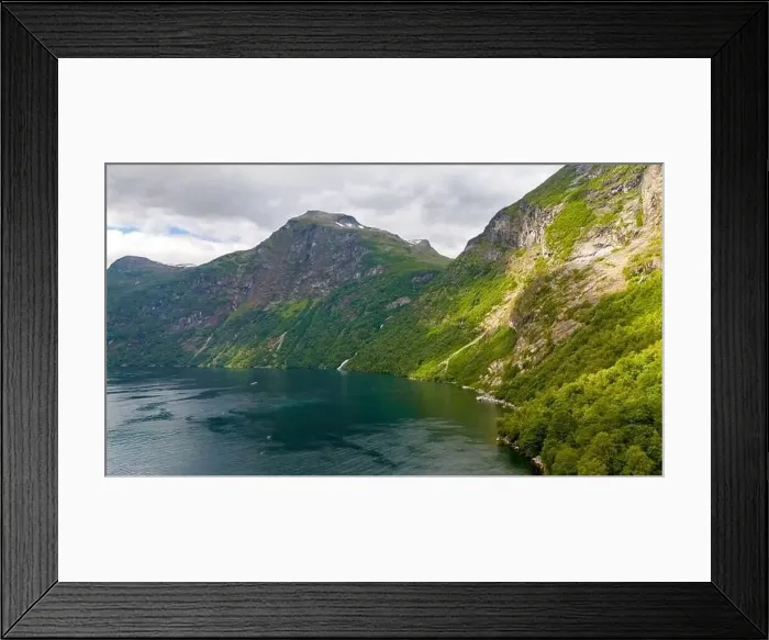 Framed Print : A tranquil scene of a Norwegian fjord surrounded by verdant mountains and a sparkling blue water surface Framed Print : A tranquil scene of a Norwegian fjord surrounded by verdant mountains and a sparkling blue water surface
