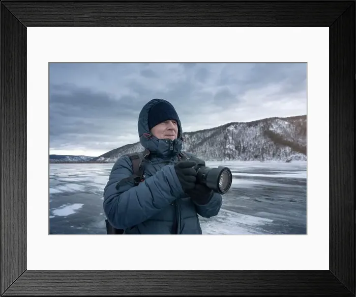 Framed Print : A photographer is capturing icy landscapes in winter gear amidst snowy mountains and frosty scenery Framed Print : A photographer is capturing icy landscapes in winter gear amidst snowy mountains and frosty scenery