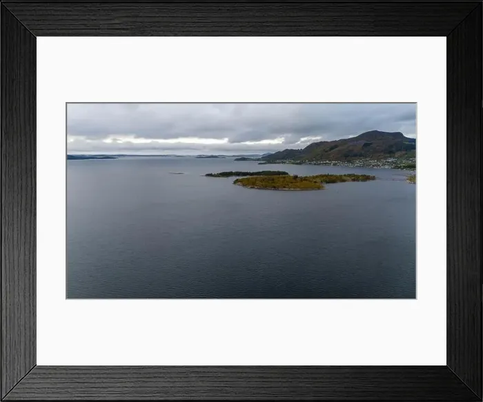 Framed Print : A serene landscape featuring a calm fjord surrounded by forested hills under a cloudy sky Framed Print : A serene landscape featuring a calm fjord surrounded by forested hills under a cloudy sky