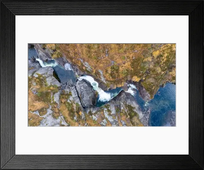 Framed Print : Aerial view of a waterfall cascading through rocky terrain surrounded by autumn foliage Framed Print : Aerial view of a waterfall cascading through rocky terrain surrounded by autumn foliage