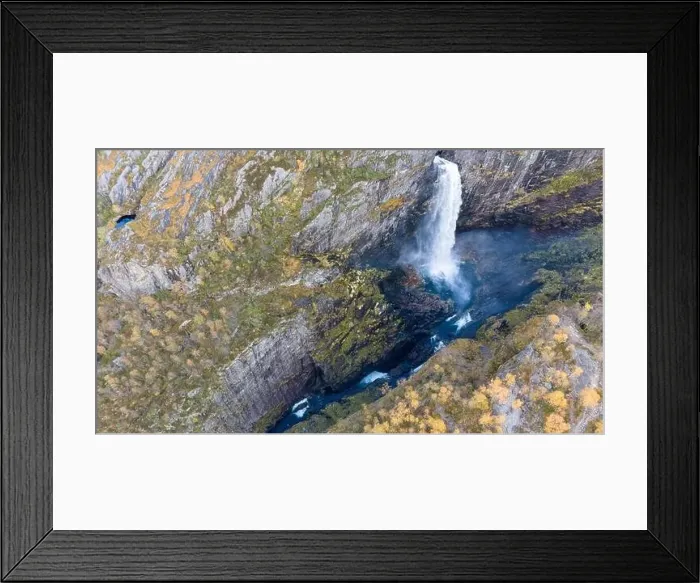 Framed Print : Aerial view of a stunning waterfall cascading down rocky cliffs into a deep blue pool surrounded by lush greenery Framed Print : Aerial view of a stunning waterfall cascading down rocky cliffs into a deep blue pool surrounded by lush greenery