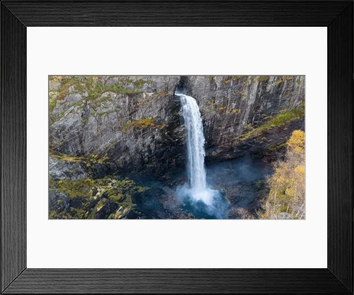Framed Print : Aerial view of a stunning waterfall cascading down rocky cliffs into a deep blue pool surrounded by lush greenery Framed Print : Aerial view of a stunning waterfall cascading down rocky cliffs into a deep blue pool surrounded by lush greenery