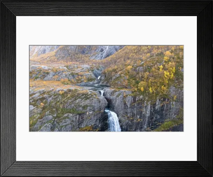 Framed Print : Aerial view of a stunning waterfall cascading down rocky cliffs into a deep blue pool surrounded by lush greenery Framed Print : Aerial view of a stunning waterfall cascading down rocky cliffs into a deep blue pool surrounded by lush greenery