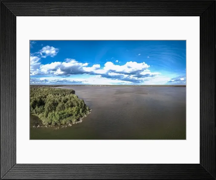 Framed Print : Big lake with green shores in bright sun light and city on horizon Framed Print : Big lake with green shores in bright sun light and city on horizon