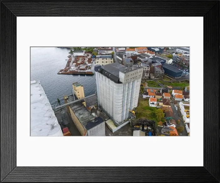 Framed Print : Aerial view of a coastal town featuring large silos Framed Print : Aerial view of a coastal town featuring large silos