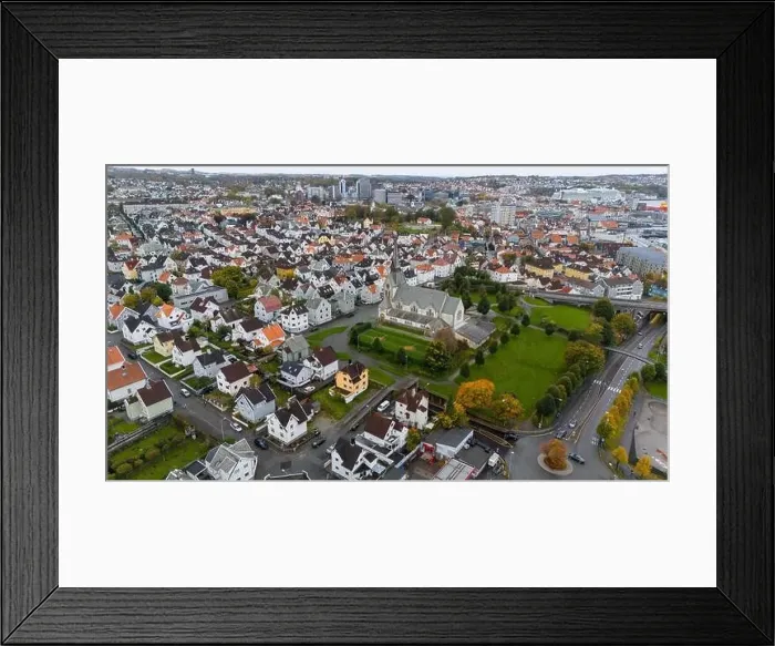 Framed Print : Aerial view of a European city with a prominent church surrounded by residential houses and greenery
