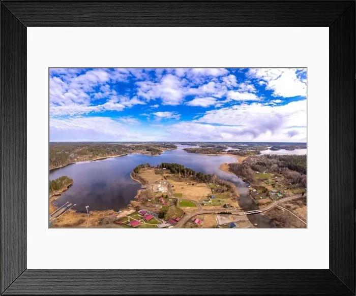 Framed Print : Aerial top view to island overgrown with sparse trees in summer sunny day