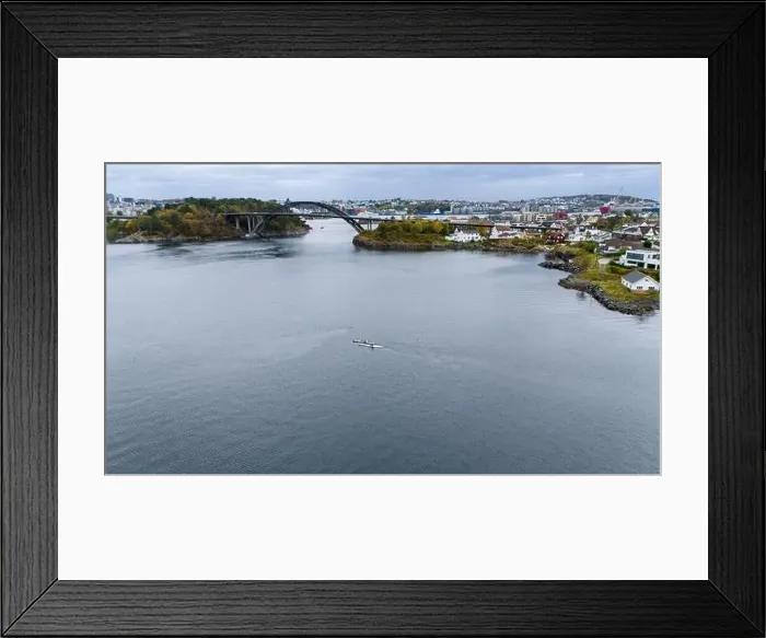 Framed Print : Aerial view of a serene coastal area with a bridge, houses, and kayakers Framed Print : Aerial view of a serene coastal area with a bridge, houses, and kayakers