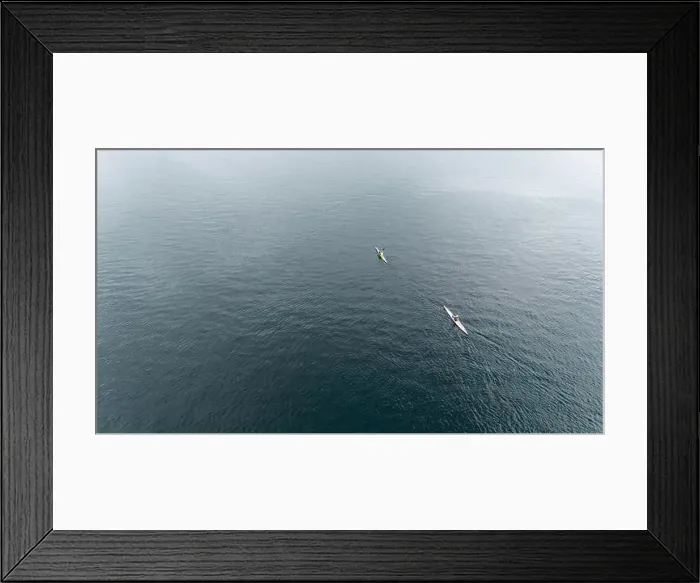 Framed Print : Aerial view of two kayakers paddling on a calm, expansive fjord Framed Print : Aerial view of two kayakers paddling on a calm, expansive fjord