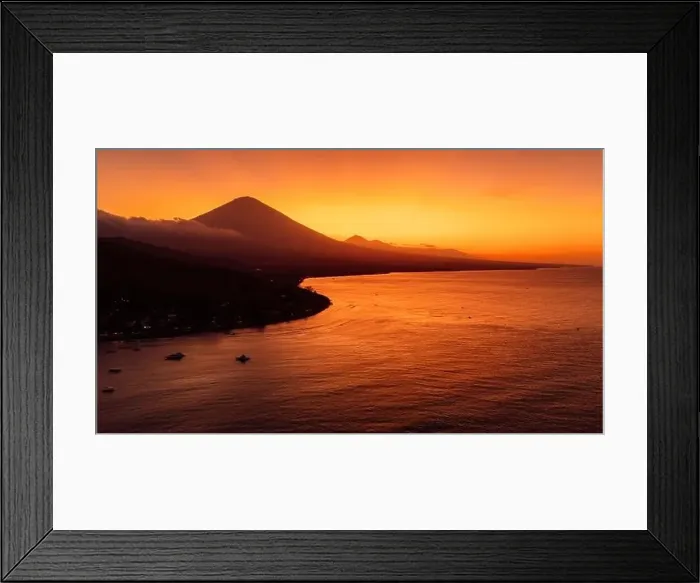 Framed Print : Drone view panorama of coastline with silhouette of volcano and sunset with quiet sea in Bali Framed Print : Drone view panorama of coastline with silhouette of volcano and sunset with quiet sea in Bali