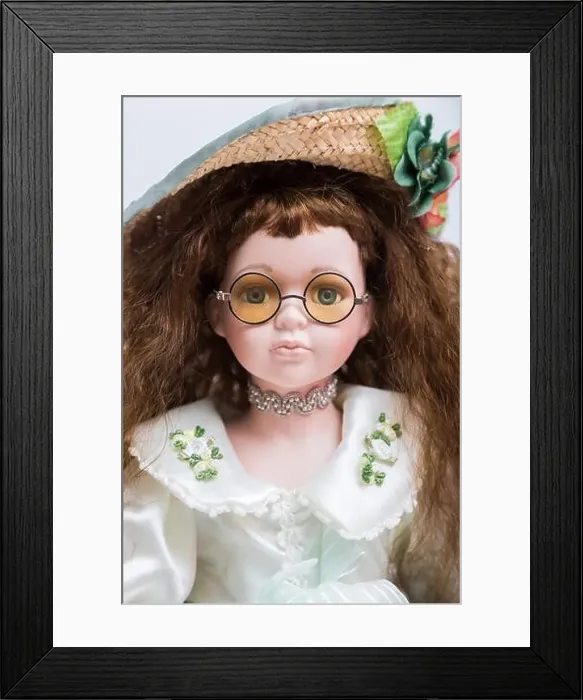 Framed Print : Portrait of a ceramic porcelain handmade vintage doll with yellow glasses Framed Print : Portrait of a ceramic porcelain handmade vintage doll with yellow glasses