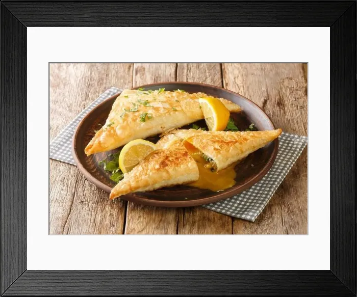 Framed Print : Tunisian Deep fried brik pastry with tuna and egg filling close up in the plate on the wooden table. Horizontal Framed Print : Tunisian Deep fried brik pastry with tuna and egg filling close up in the plate on the wooden table. Horizontal