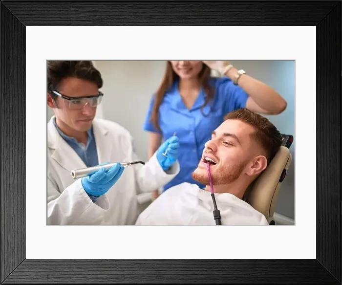Framed Print : Young man at dentist repairing teeth Framed Print : Young man at dentist repairing teeth