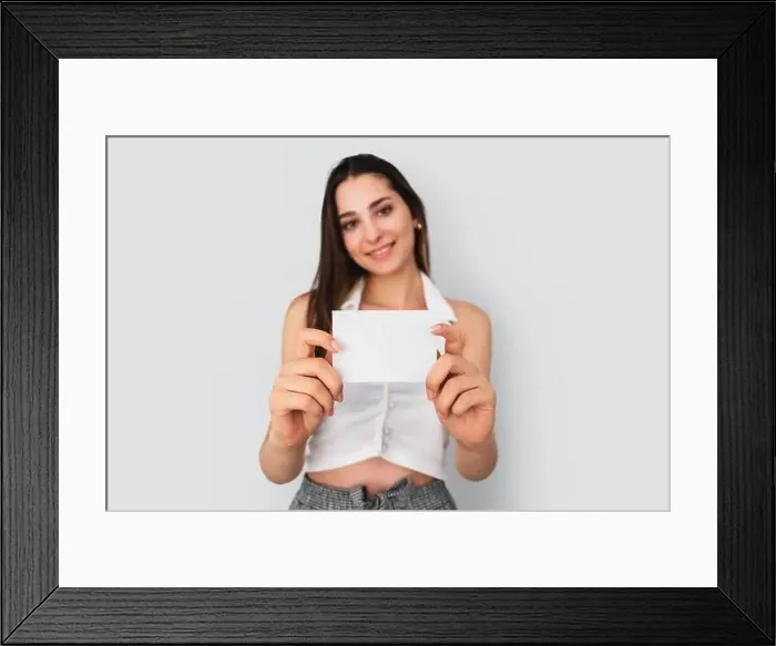 Framed Print : Young brunette woman is holding a blank note paper for mock up use. Silent communication concept. High quality photo Framed Print : Young brunette woman is holding a blank note paper for mock up use. Silent communication concept. High quality photo