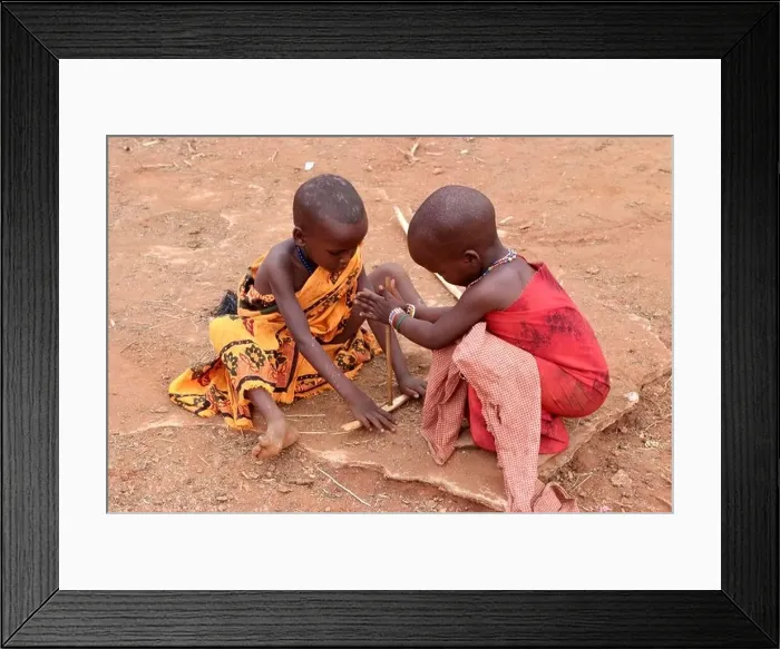 Framed Print : Massai children are pretending to ignite a fire, Kenya, Africa