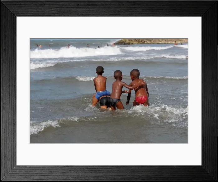 Framed Print : Four young boys playing in the Caribbean sea in Cartagena, Colombia Framed Print : Four young boys playing in the Caribbean sea in Cartagena, Colombia