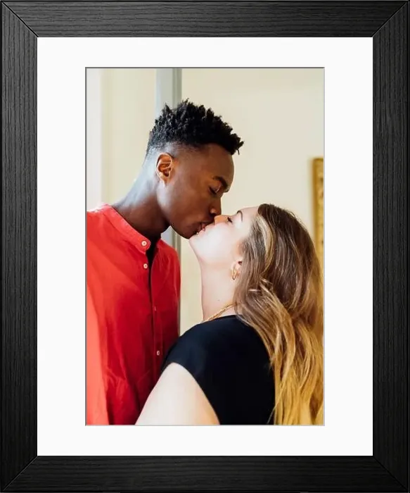 Framed Print : Couple with closed eyes kissing each other at home Framed Print : Couple with closed eyes kissing each other at home