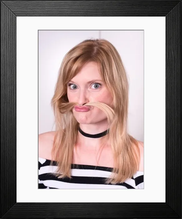 Framed Print : beautiful blonde woman is making a mustache with her hair Framed Print : beautiful blonde woman is making a mustache with her hair