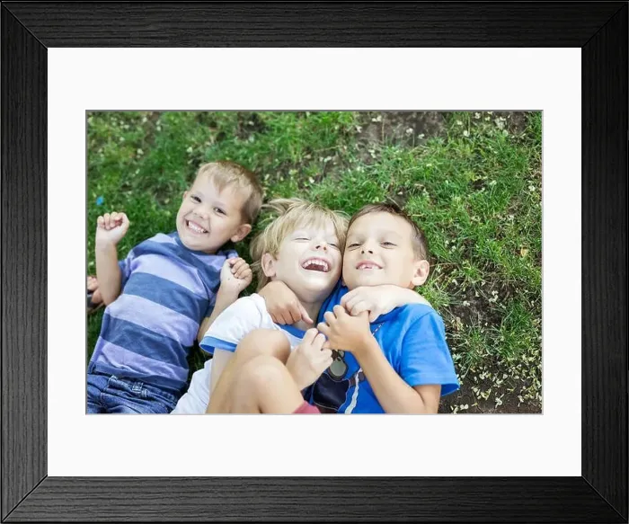 Framed Print : Three happy young boys in summer park. Friends or siblings hugging and laughing while lying down on green grass Framed Print : Three happy young boys in summer park. Friends or siblings hugging and laughing while lying down on green grass