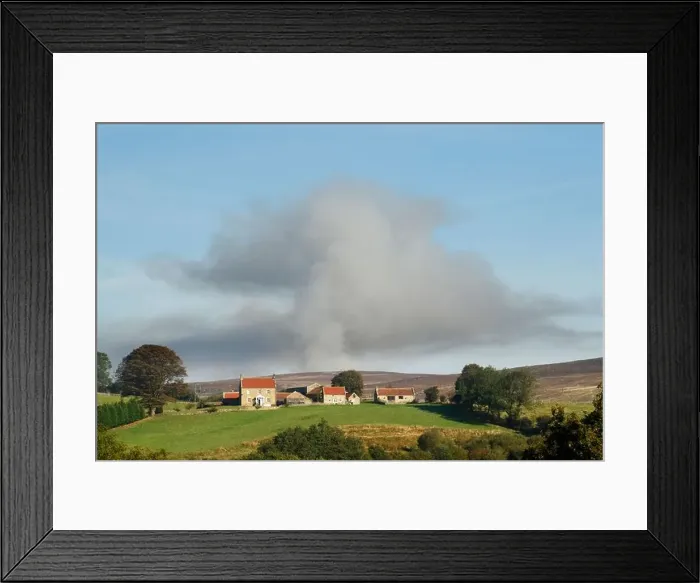 Framed Print : Smoke plume billowing up over moorland behind a farmhouse due to heather burning as part of red grouse habitat Framed Print : Smoke plume billowing up over moorland behind a farmhouse due to heather burning as part of red grouse habitat