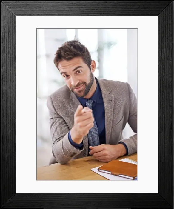 Framed Print : What can I do for you. a young man sitting in his office Framed Print : What can I do for you. a young man sitting in his office