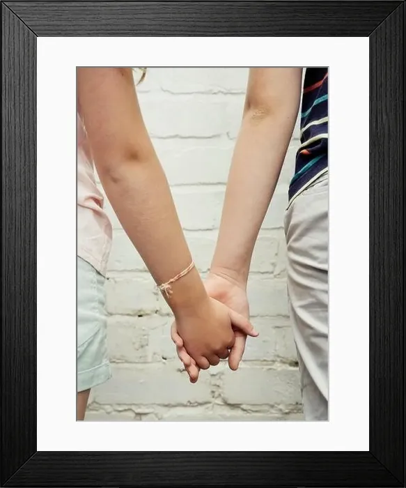 Framed Print : Two children hold hands facing away from the camera