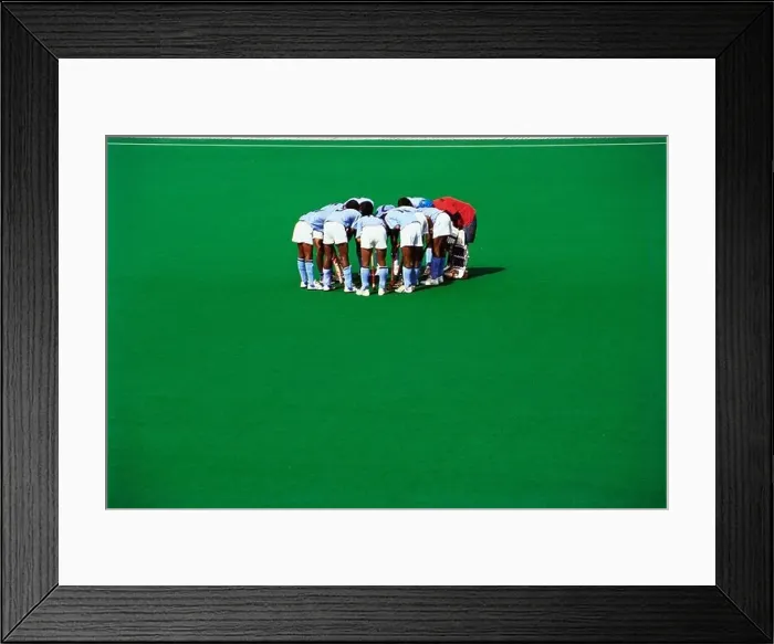 Framed Print : Hockey players conference huddle on green astro turf ground