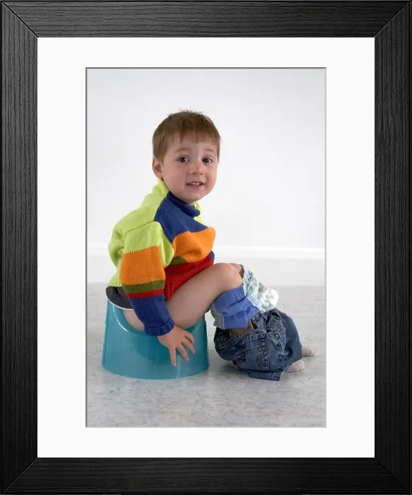Framed Print : Young boy sitting on a potty England UK CJWH