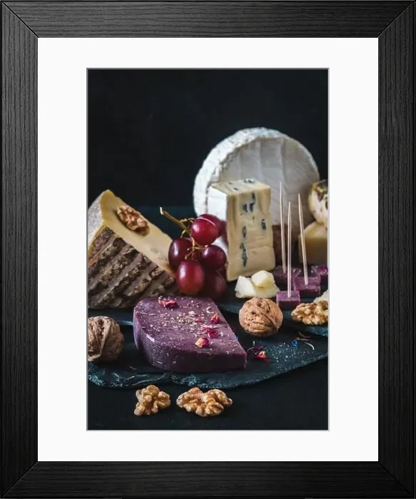 Framed Print : Variety of exclusive and colorful cheese, decorated with red grapes, on black background, vertical Framed Print : Variety of exclusive and colorful cheese, decorated with red grapes, on black background, vertical
