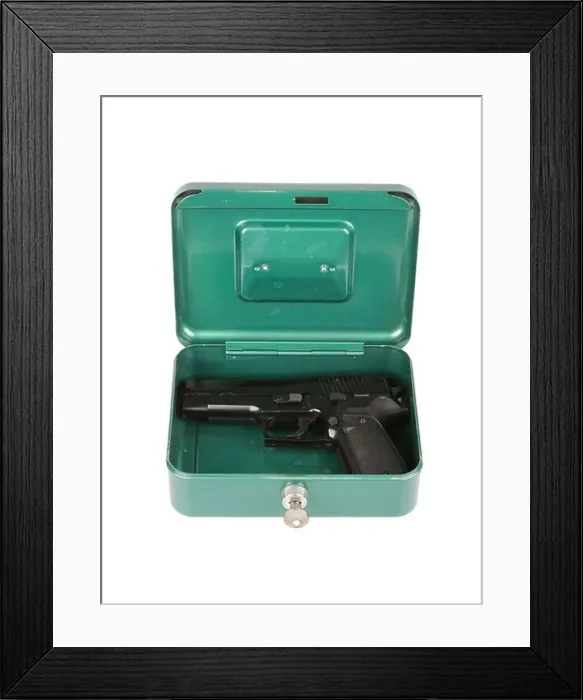 Framed Print : 9mm pistol in a metal case, isolated on white Framed Print : 9mm pistol in a metal case, isolated on white