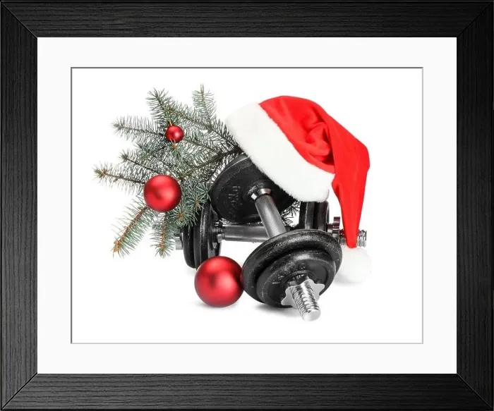 Framed Print : Dumbbells and Christmas decor isolated on white Framed Print : Dumbbells and Christmas decor isolated on white