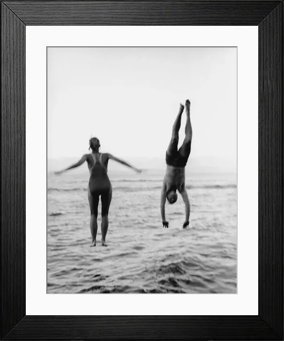 Framed Print : Couple Jumping and Diving into Water Framed Print : Couple Jumping and Diving into Water