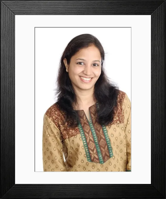 Framed Print : Portrait of Beautiful Smiling Indian girl against white Framed Print : Portrait of Beautiful Smiling Indian girl against white