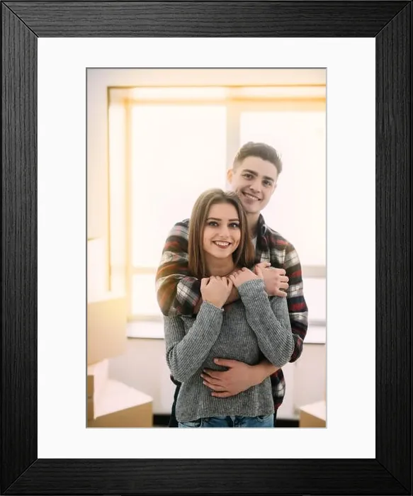 Framed Print : Cute couple hugging and smiling in their new home Framed Print : Cute couple hugging and smiling in their new home