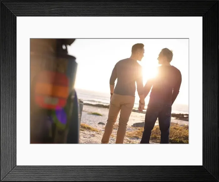 Framed Print : Happy caucasian gay male couple holding hands, walking away from car at seaside Framed Print : Happy caucasian gay male couple holding hands, walking away from car at seaside