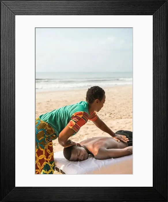 Framed Print : Woman massaging man on beach Framed Print : Woman massaging man on beach