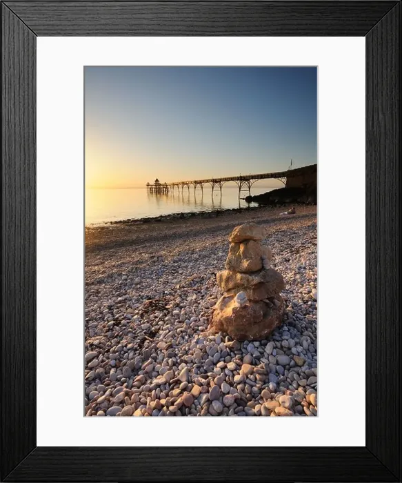 Framed Print : Clevedon Pier, Somerset, with a stone stack in the foreground, during the golden hour before sunset Framed Print : Clevedon Pier, Somerset, with a stone stack in the foreground, during the golden hour before sunset